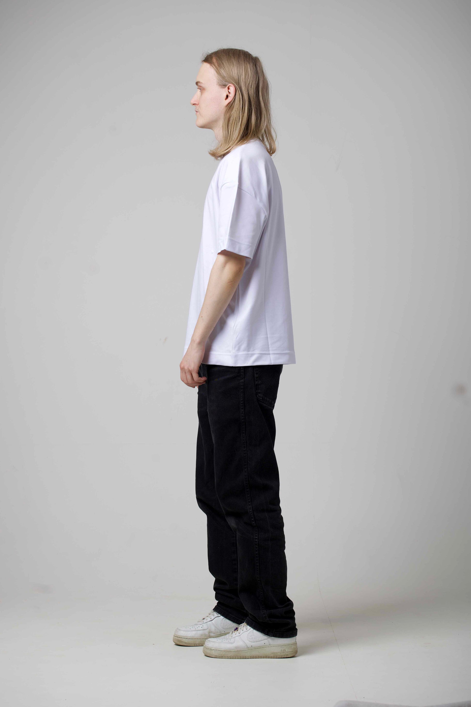 BBAP white oversized t-shirt side view on male model – relaxed fit oversized silhouette